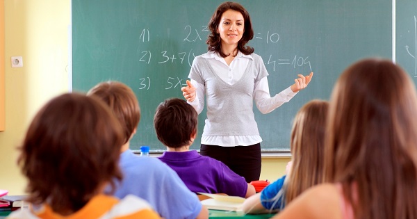 Teacher and student in a classroom at school.