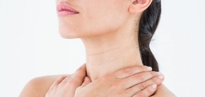 Sick brunette having throat pain